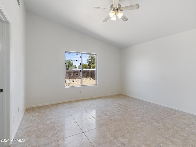 unfurnished room with vaulted ceiling, light tile patterned floors, and ceiling fan