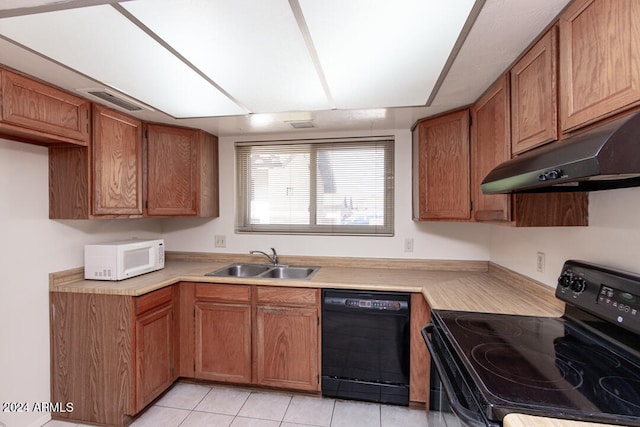 kitchen with black appliances, sink, and light tile patterned floors