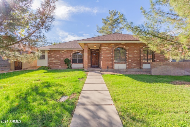 ranch-style home featuring a front yard