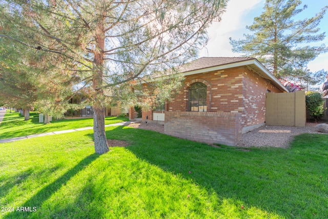 view of side of property with a lawn