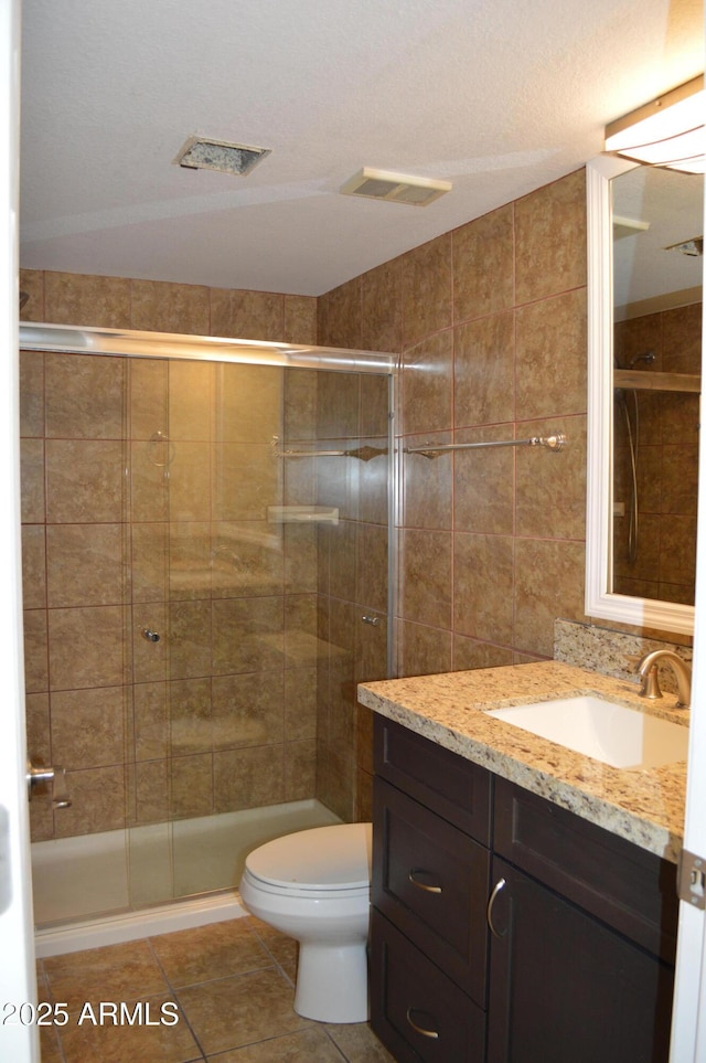 full bath featuring a stall shower, visible vents, and tile patterned floors