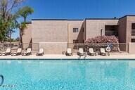 pool featuring a patio and fence