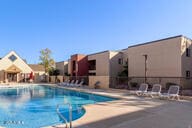 view of pool featuring a residential view and a patio area