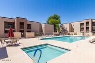 pool featuring a patio and a hot tub