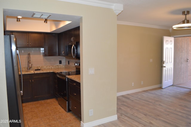 kitchen with visible vents, appliances with stainless steel finishes, ornamental molding, a sink, and backsplash