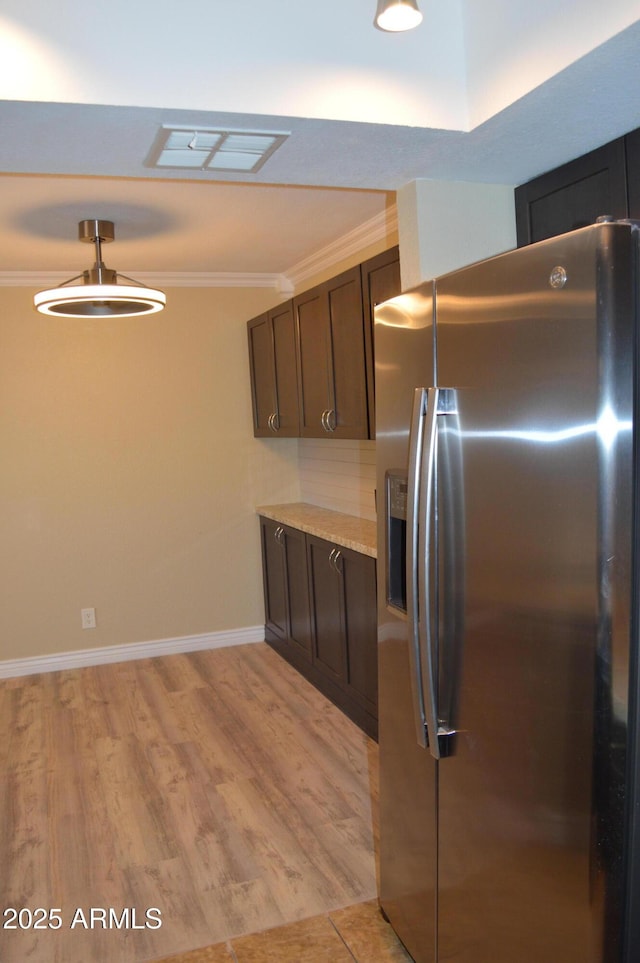 kitchen featuring light wood-style floors, visible vents, ornamental molding, and stainless steel refrigerator with ice dispenser