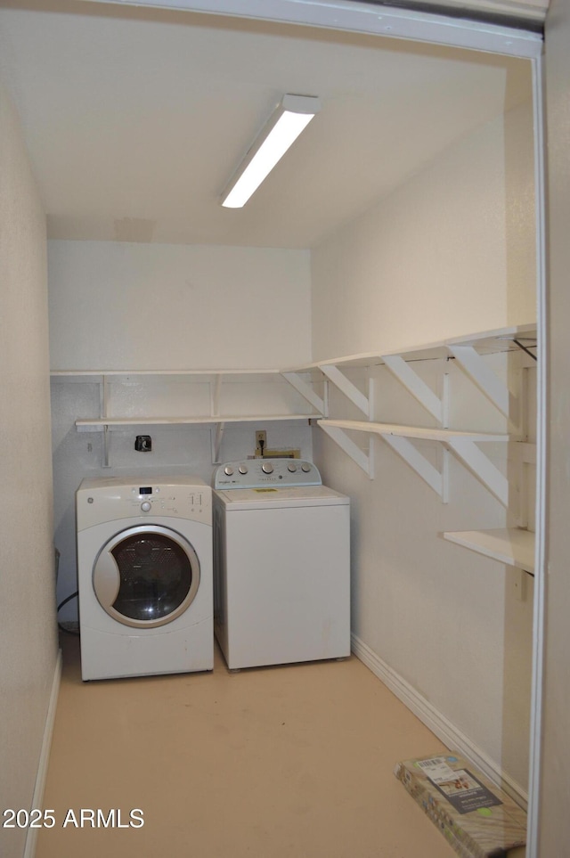 laundry area with washer and dryer, laundry area, and baseboards