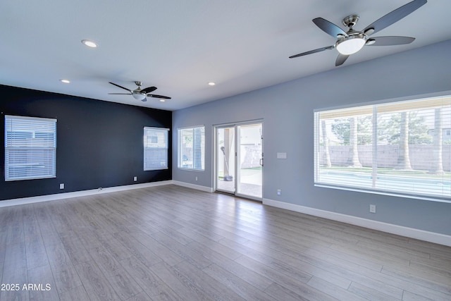 unfurnished room with a ceiling fan, recessed lighting, baseboards, and wood finished floors