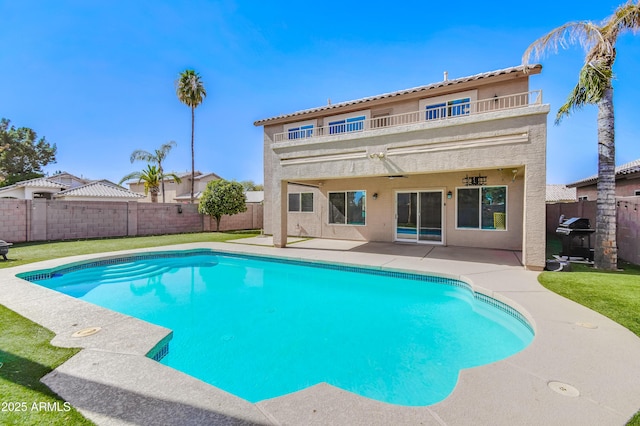 view of swimming pool with a fenced in pool, a patio area, a fenced backyard, and a lawn