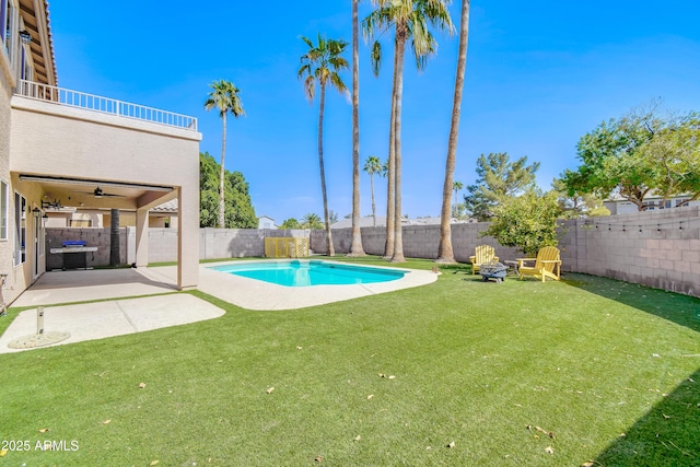 view of swimming pool featuring a yard, a patio area, a fenced backyard, and a fenced in pool