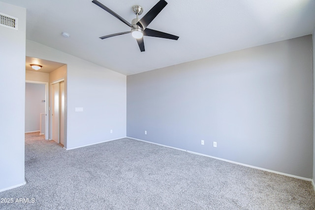 unfurnished room with ceiling fan, carpet flooring, visible vents, and baseboards