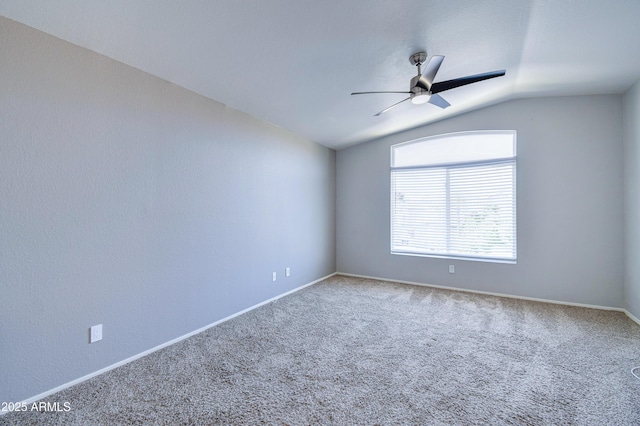 spare room with carpet floors, lofted ceiling, ceiling fan, and baseboards