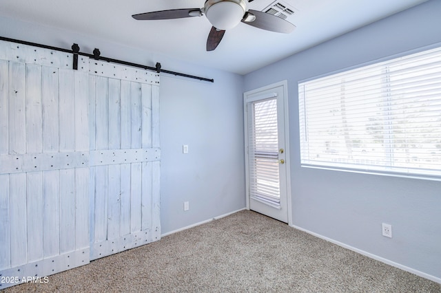 unfurnished room with carpet flooring, ceiling fan, visible vents, and baseboards