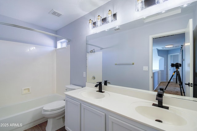 bathroom with toilet, visible vents, a sink, and bathing tub / shower combination