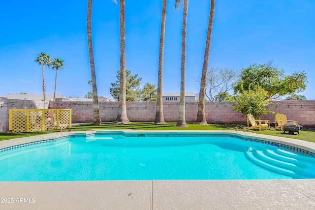 view of swimming pool with a fire pit, a fenced backyard, and a fenced in pool