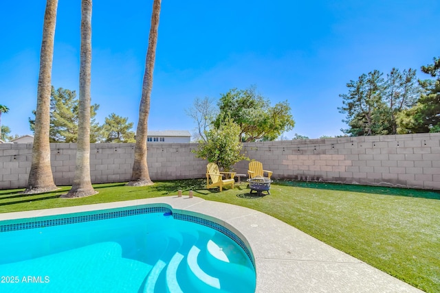 view of swimming pool featuring a fenced in pool, a fenced backyard, a lawn, and a fire pit