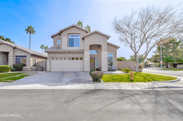 mediterranean / spanish house featuring concrete driveway, a tiled roof, an attached garage, fence, and stucco siding