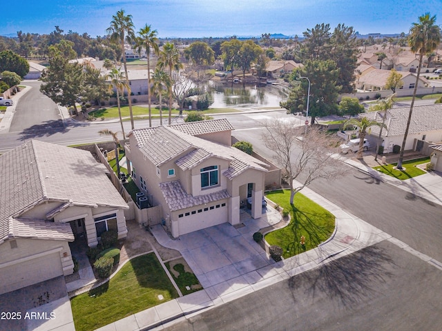 drone / aerial view with a residential view and a water view