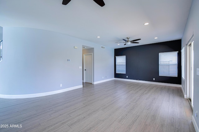 spare room with recessed lighting, visible vents, light wood-style floors, ceiling fan, and baseboards