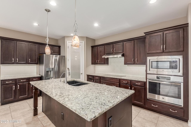 kitchen with appliances with stainless steel finishes, a sink, light tile patterned floors, decorative backsplash, and recessed lighting