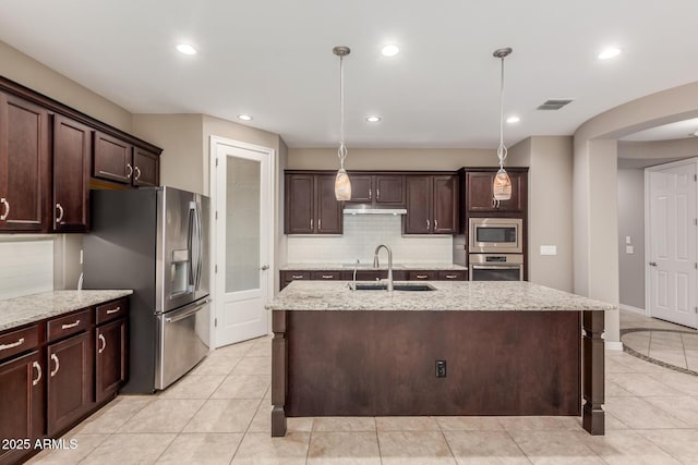 kitchen with appliances with stainless steel finishes, a sink, dark brown cabinets, tasteful backsplash, and recessed lighting