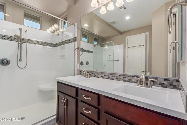 full bath with a shower stall and double vanity