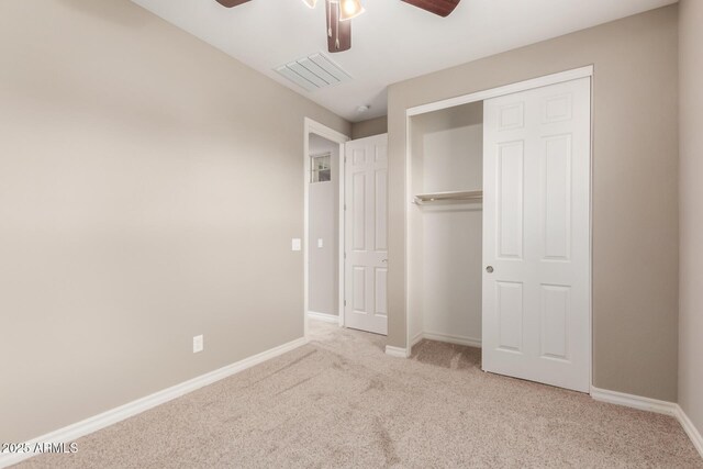 unfurnished bedroom featuring carpet flooring, baseboards, a closet, and ceiling fan