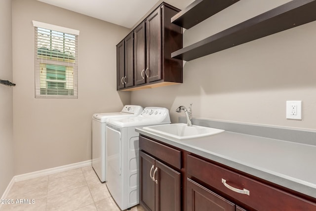 laundry room with cabinet space, separate washer and dryer, baseboards, and light tile patterned flooring