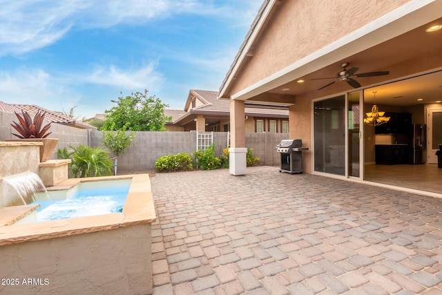 view of patio / terrace featuring a fenced backyard, ceiling fan, and a grill