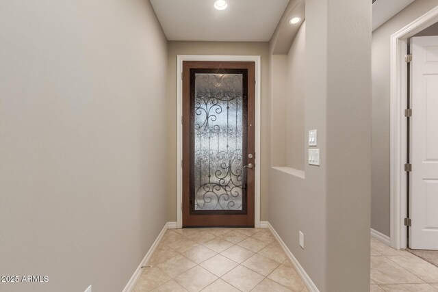doorway featuring light tile patterned floors, recessed lighting, and baseboards