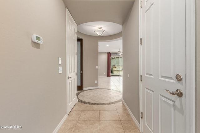 corridor featuring light tile patterned floors, baseboards, inlaid floor details, and recessed lighting
