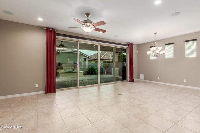 spare room with a chandelier, ceiling fan, recessed lighting, light tile patterned floors, and baseboards