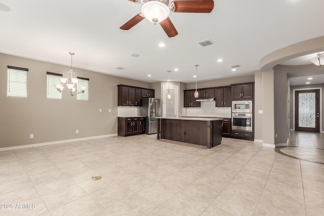 kitchen featuring stainless steel appliances, light countertops, dark brown cabinetry, a chandelier, and recessed lighting