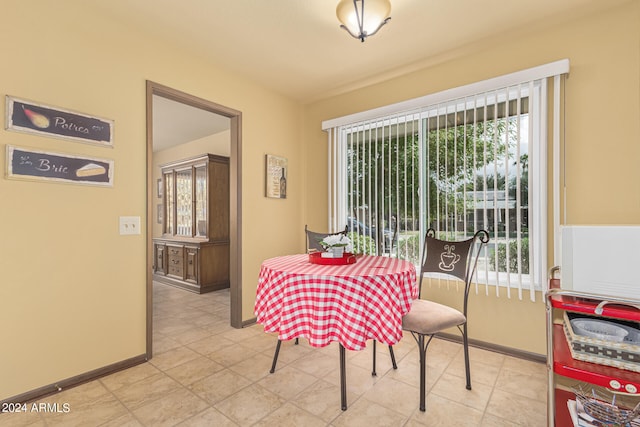 dining space featuring plenty of natural light and light tile patterned floors