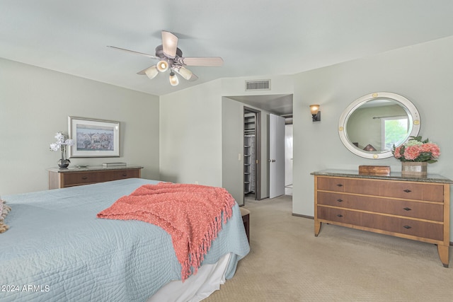 bedroom with ceiling fan and light colored carpet