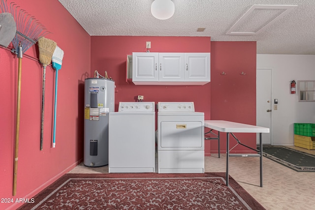 clothes washing area with a textured ceiling, electric water heater, cabinets, washing machine and dryer, and carpet flooring