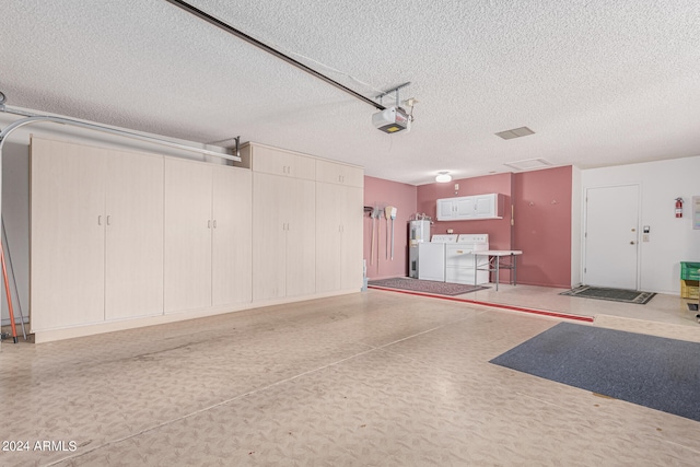 garage featuring refrigerator, electric water heater, a garage door opener, and washing machine and clothes dryer