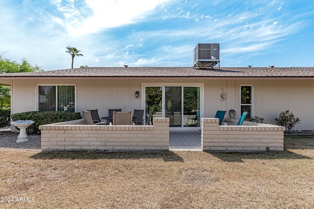 rear view of house with central AC unit and a patio area