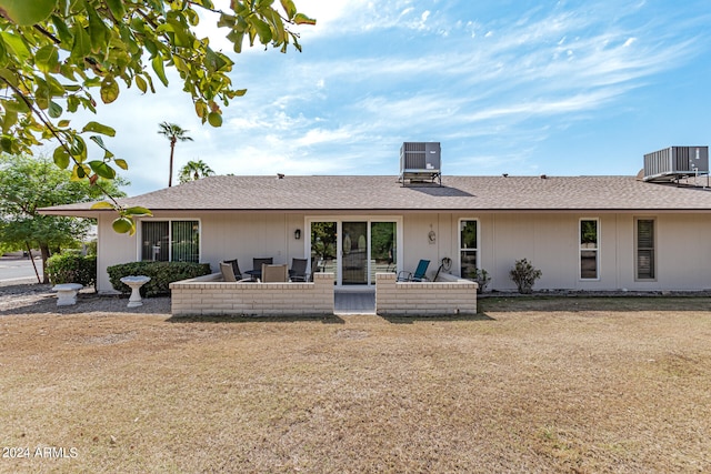 back of house featuring a patio, a lawn, and central AC unit