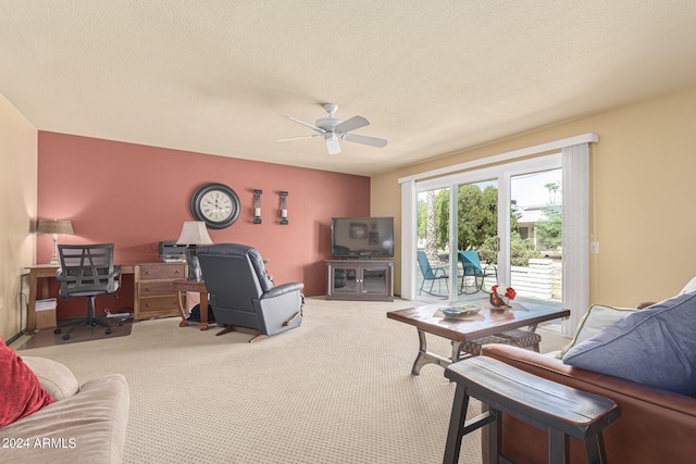 carpeted living room featuring a textured ceiling and ceiling fan