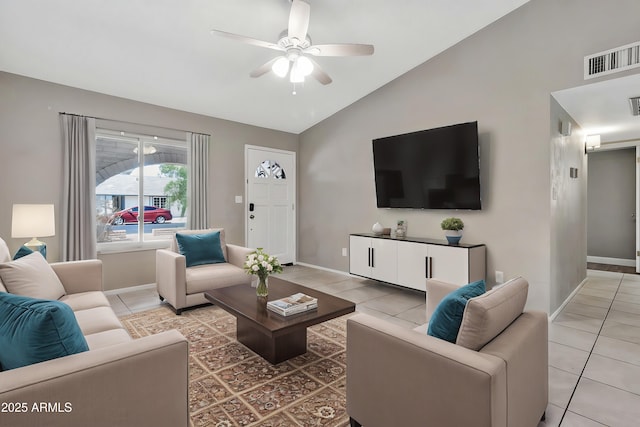 living area with light tile patterned flooring, vaulted ceiling, ceiling fan, and visible vents
