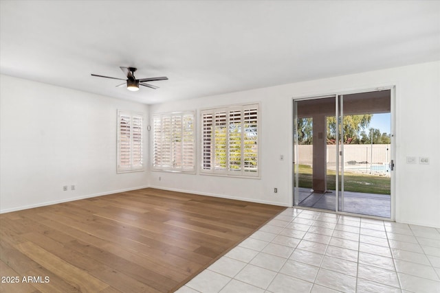 unfurnished room featuring light tile patterned floors and ceiling fan