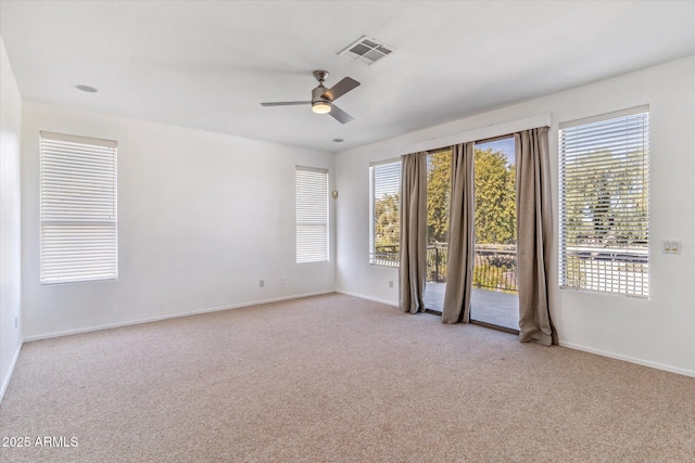 empty room with light colored carpet and ceiling fan