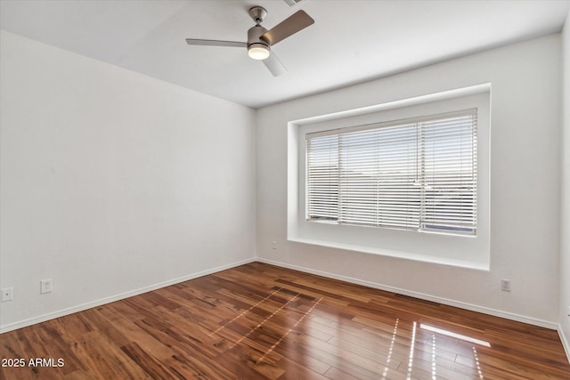 spare room with ceiling fan and dark hardwood / wood-style flooring