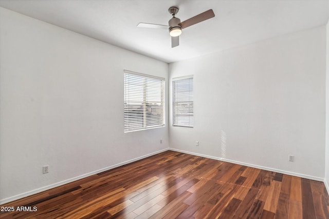 spare room featuring dark wood-type flooring and ceiling fan