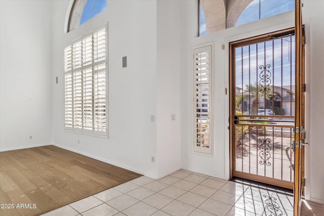 tiled foyer featuring a high ceiling