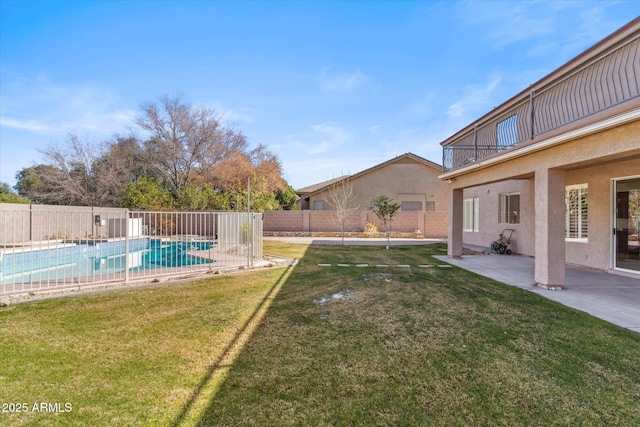 view of yard featuring a fenced in pool, a patio area, and a balcony