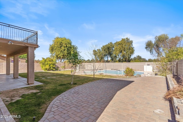 view of patio / terrace featuring a fenced in pool and a balcony