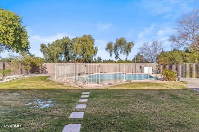 view of swimming pool featuring a lawn