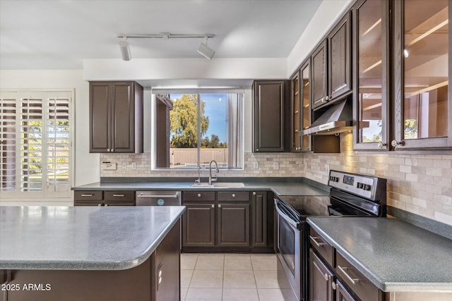 kitchen with light tile patterned flooring, appliances with stainless steel finishes, sink, decorative backsplash, and dark brown cabinetry